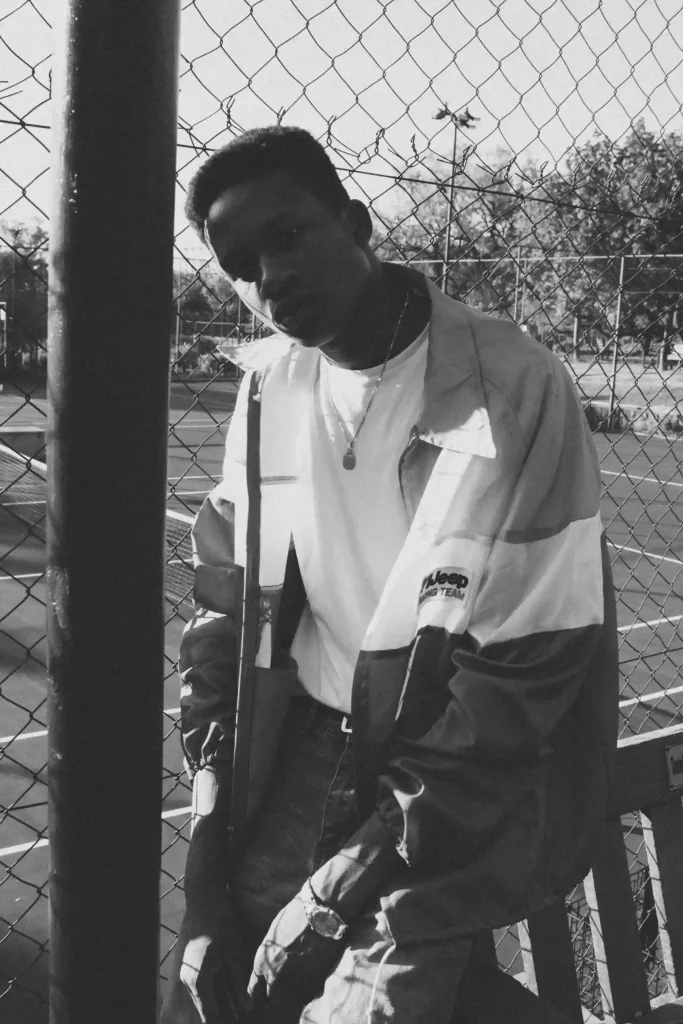 A young African American hip-hop enthusiast expressing identity through 90's inspired apparel