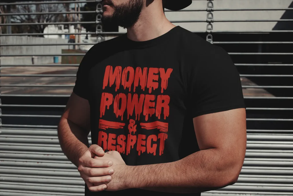 A close-up of a t-shirt design featuring a powerful, uplifting gangsta rap lyric in a red, bold, clean font, symbolizing resilience and ambition.