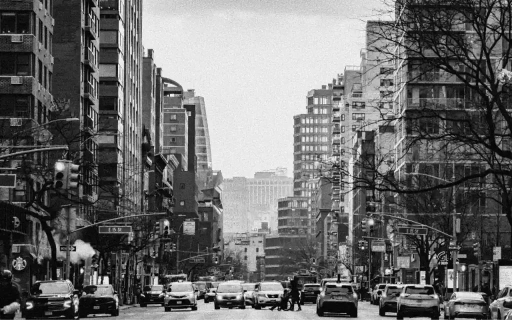 A black and white image of an urban street scene, evoking the socio-economic conditions that influenced early gangsta rap lyrics.